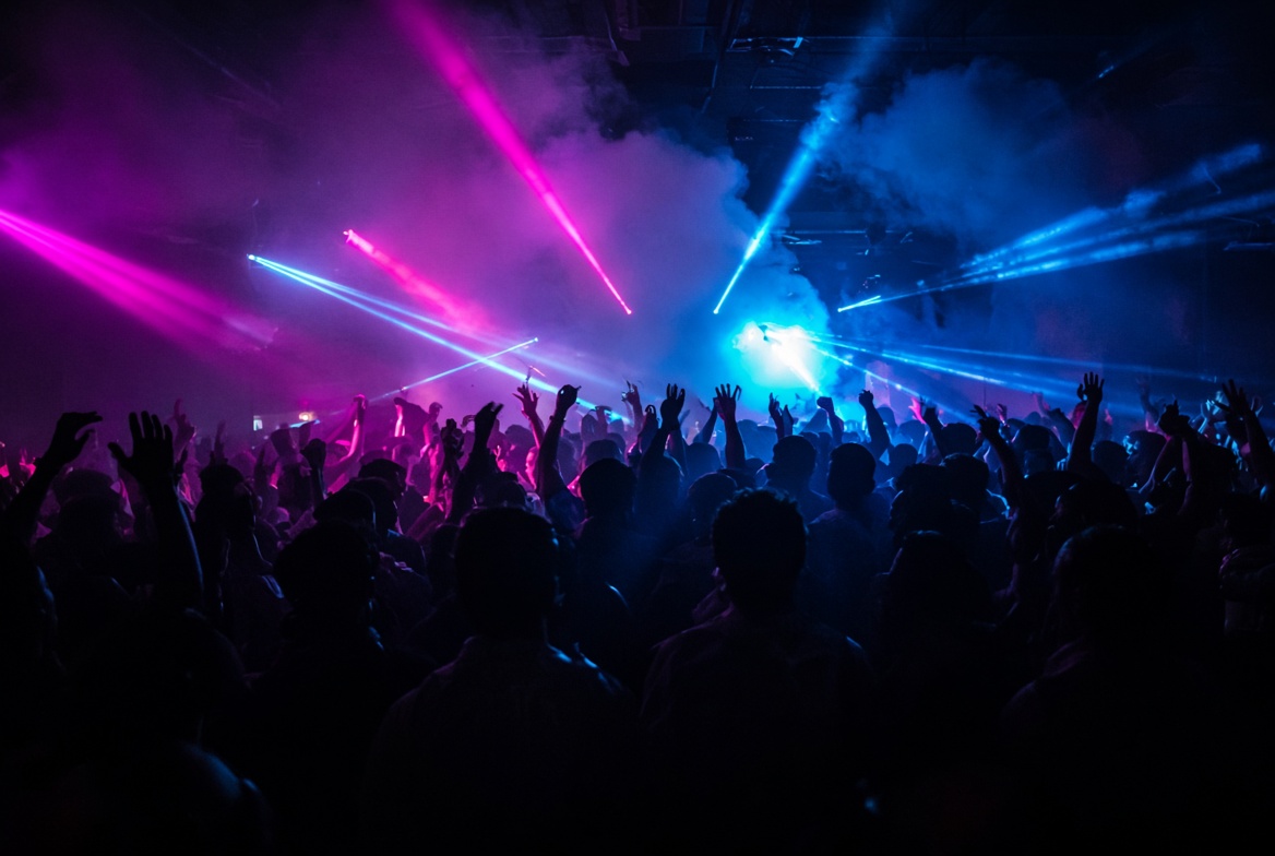 Circuit party crowd under magenta and cyan lasers